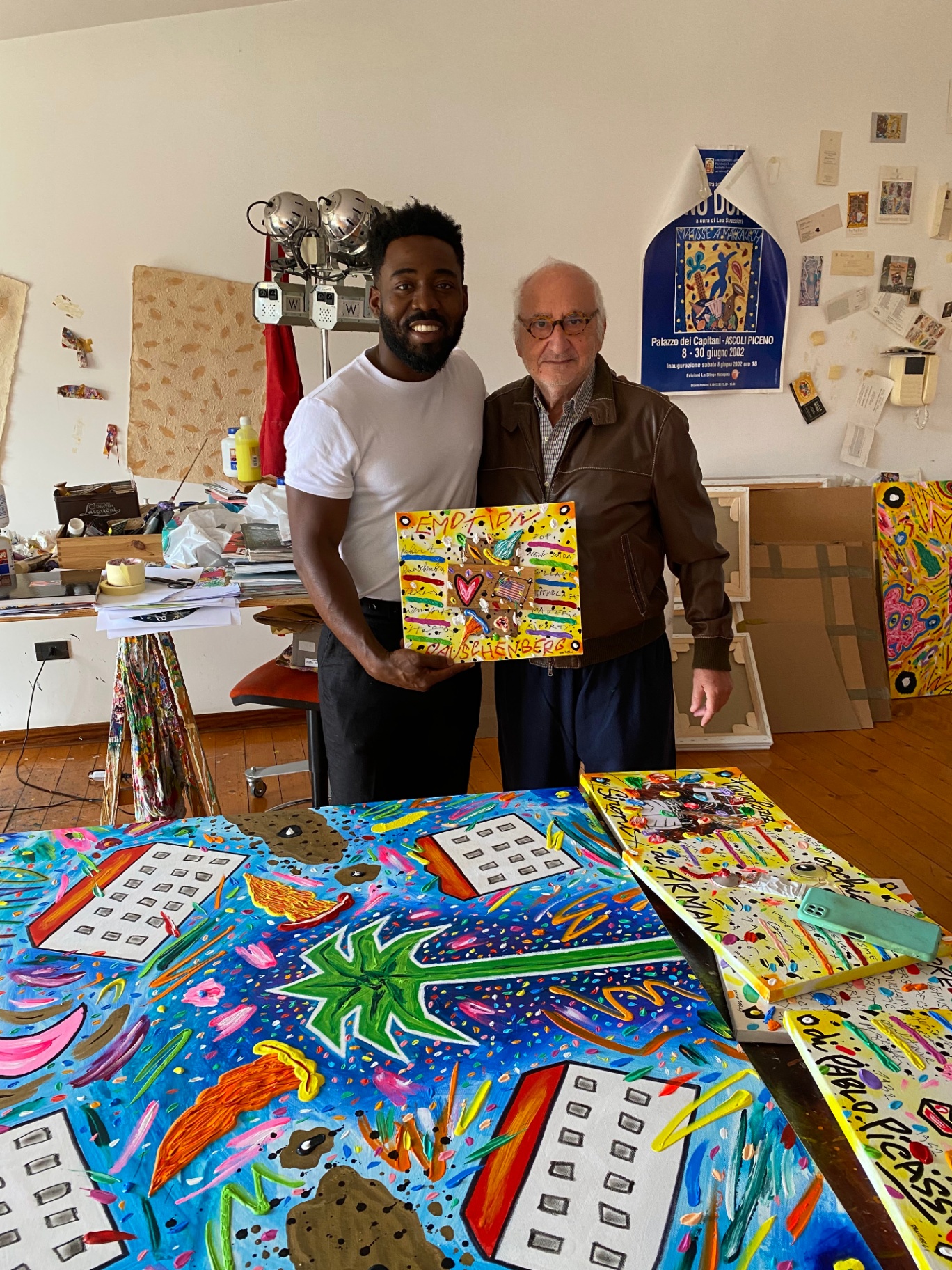 12 Brass Street with Italian artist Bruno Donzelli holding a signed canvas
